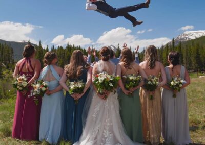 Wedding videography and photography of fun wedding traditions such as throwing the groom in the air for this awesome real photo