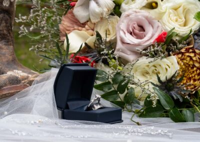 wedding photography of details such as ring, flowers, boots, perfume and vail.