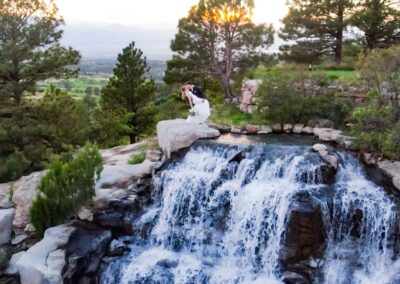 beautiful dip kiss on top of waterfall wedding photographer